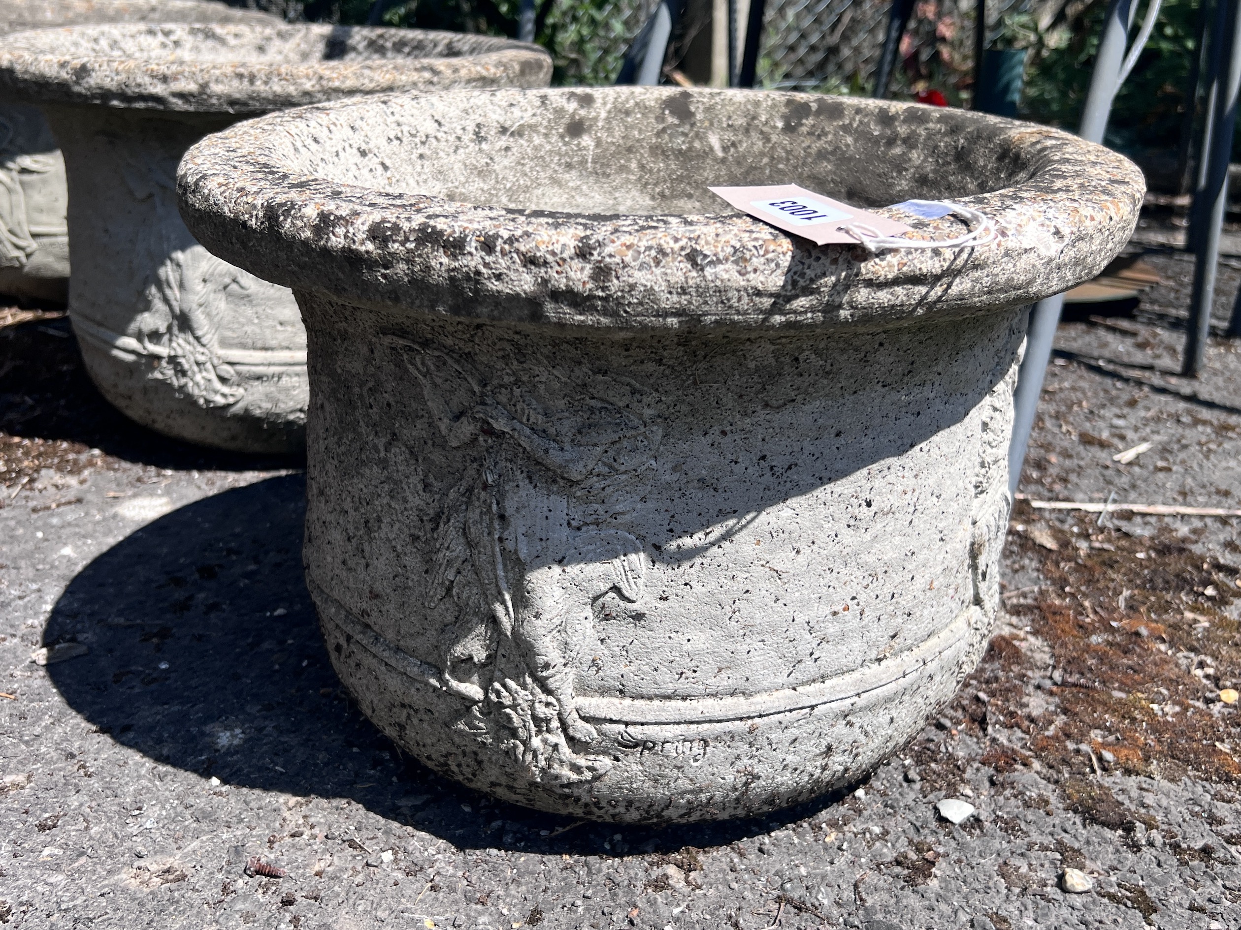 A set of four circular reconstituted stone garden planters, diameter 41cm, height 28cm